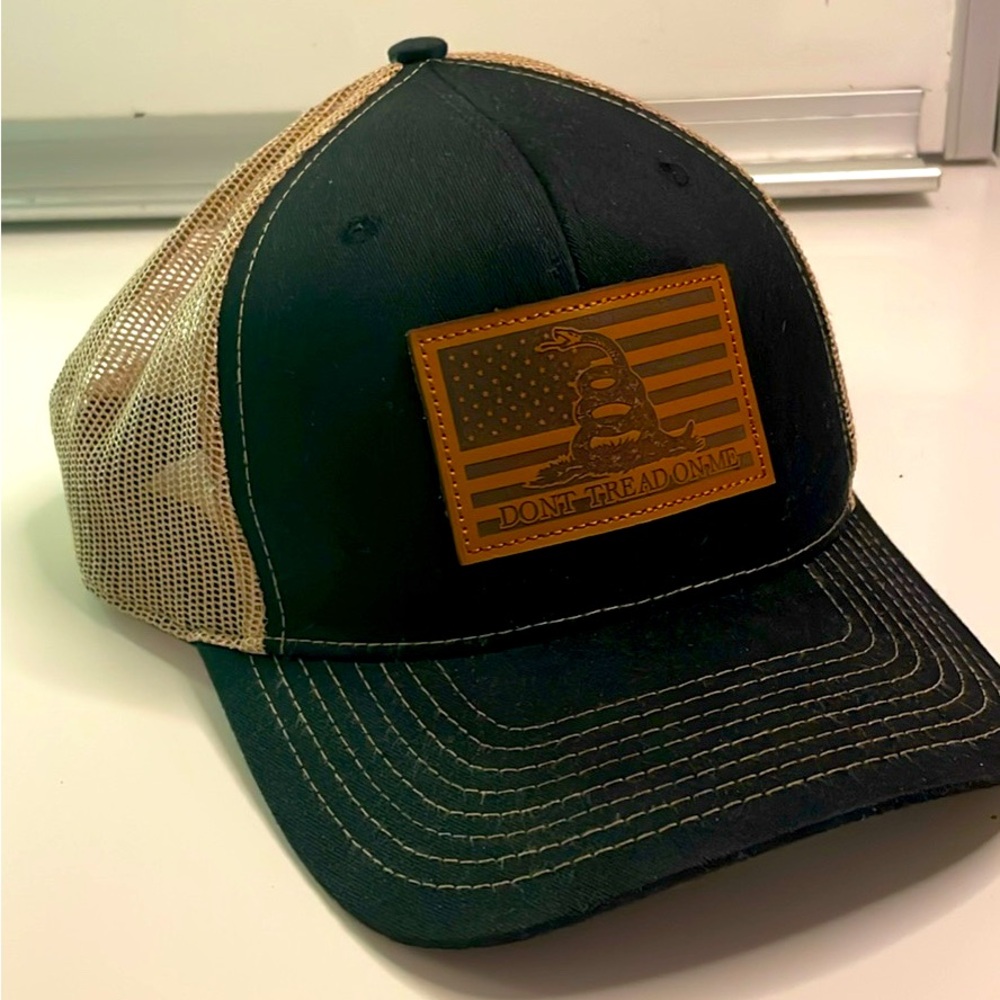 NWOT black trucker hat with leather patch